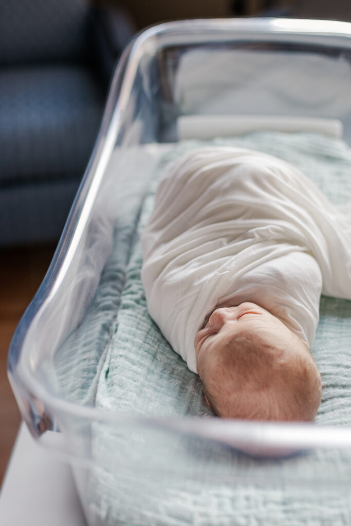 Newborn baby boy peacefully sleeping in a hospital crib during a Fresh-48 session at UAB in Birmingham, Alabama, captured by 5U Photography