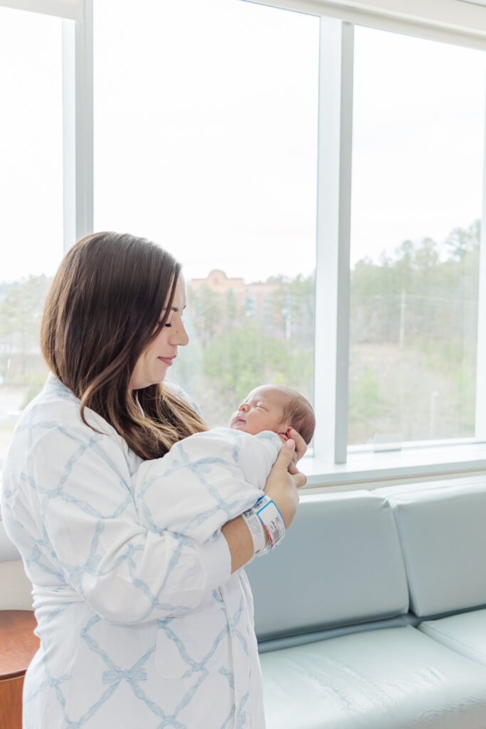 New mom holding baby James in a tender, intimate moment captured during their Fresh 48 session at Grandview Medical Center.
