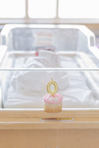 picture of pink cupcake with zero candle sitting on hospital crib at St. Vincent's Hospital 