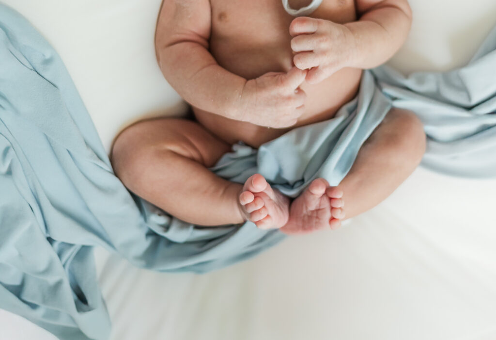 close up of newborn baby boy feet during cozy in-home newborn session in Birmingham, AL
