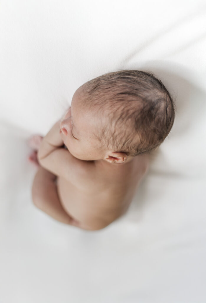 newborn baby boy lying on stomach during cozy in-home newborn session with 5U Photography in Birmingham, AL