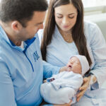 Mom and dad looking down lovingly at newborn baby boy during in-hospital session at Grandview medical center in birmingham AL