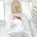 Baby girl swaddled in crib at Brookwood Hospital during fresh-48 session with 5U Photography as apart of milestone membership