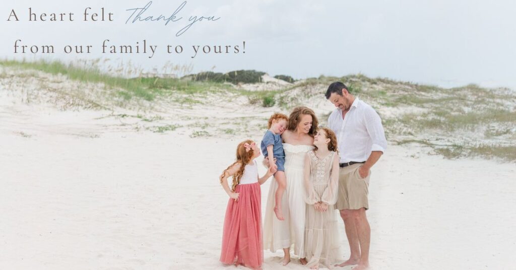 Uselton family, owners of 5U Photography standing all together looking down at each other at the beach club on fort morgan road in gulf shores alabama