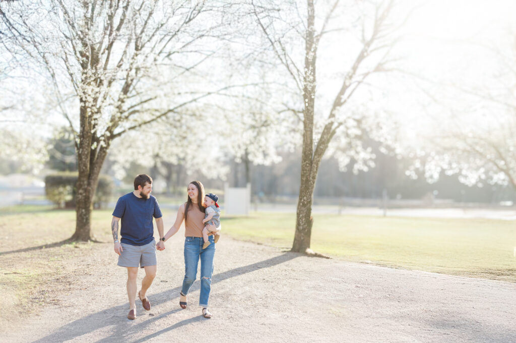 A candid moment of the Long family walking hand in hand, surrounded by nature’s beauty in Fultondale.