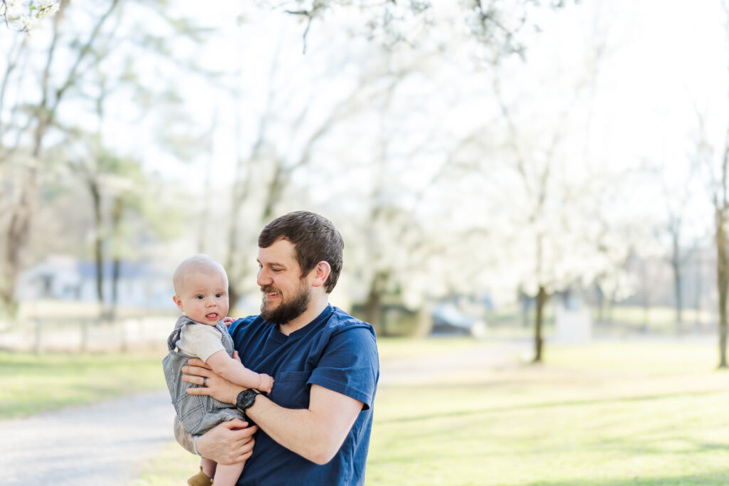 Dad holding son during spring milestone session with 5U Photography