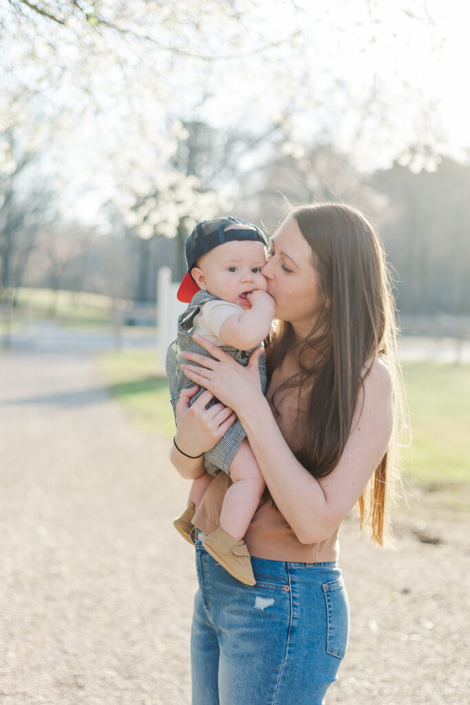 Mom holding baby in a close embrace, showing warmth and love in the milestone session.