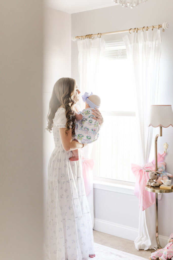 The McBrayer family’s light and airy pink and white nursery with soft natural light and delicate bow accents