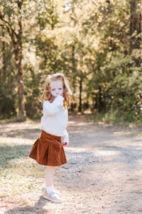 Little girl standing in fall photo styled outfit at Old Baker Farm during fall mini session in Birmingham AL with 5U Photography