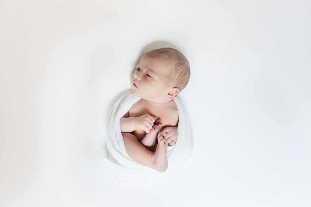 Candid connection during the Lavender family's baby-led in-home newborn session