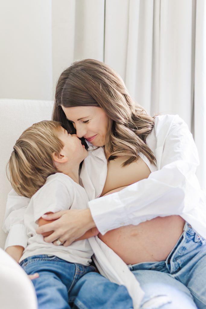 Mom cuddling and kissing her son during the Lavender family's Birmingham newborn session