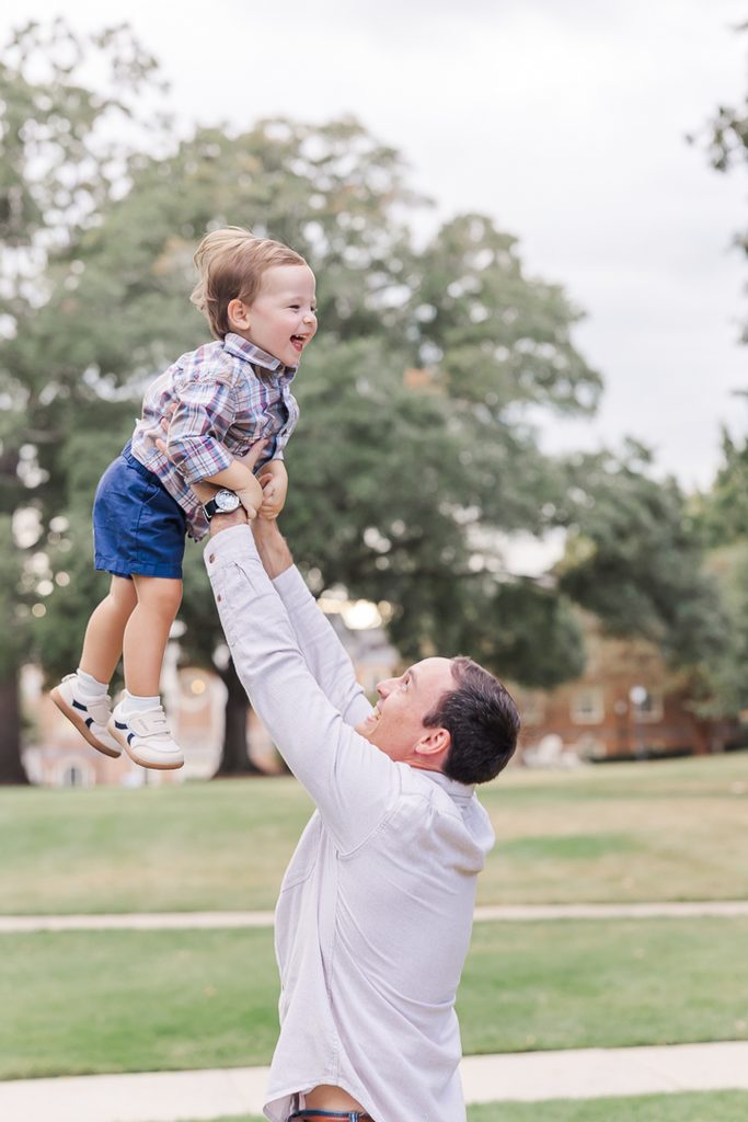 Dad lifting Liam into the air during their Birmingham family session.