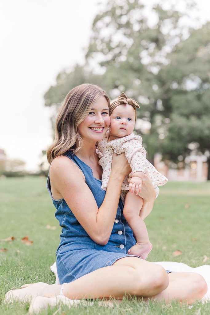 Courtney smiling with baby Harper during their family session.