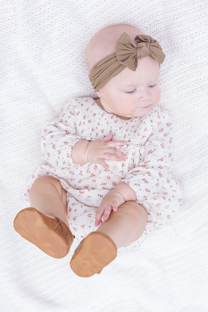 Six-month-old Harper wearing a bow during her milestone session.