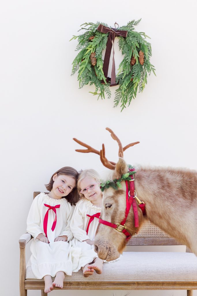 Children in festive pajamas posing for outdoor Christmas portraits.