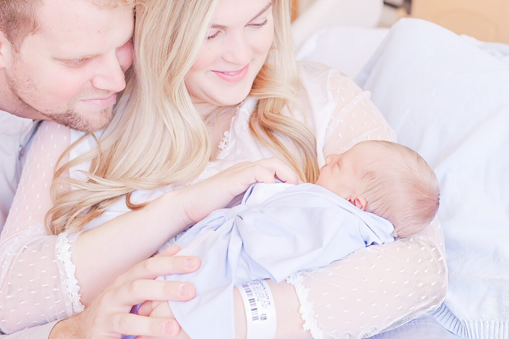 Mom and Dad holding newborn in hospital after birth for fresh- 48 photo session in birmingham alabama with 5U Photography