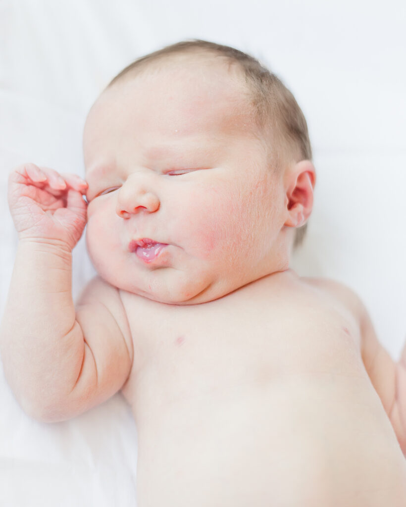 Picture of newborn baby with eyes closed during fresh 48 session in Birmingham, AL 