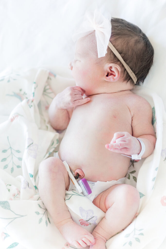 Newborn Baby sleeping in diaper laying on bed during fresh 48 session at Grandview Medical Center in Birmingham AL with 5U Photography 