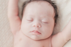 close up of baby girls face laying with eyes closed during 5U Photography session