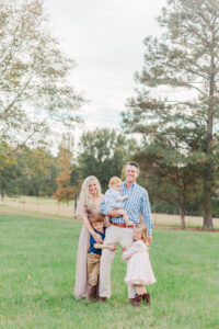 Family standing all together smiling during photography session with 5U Photography