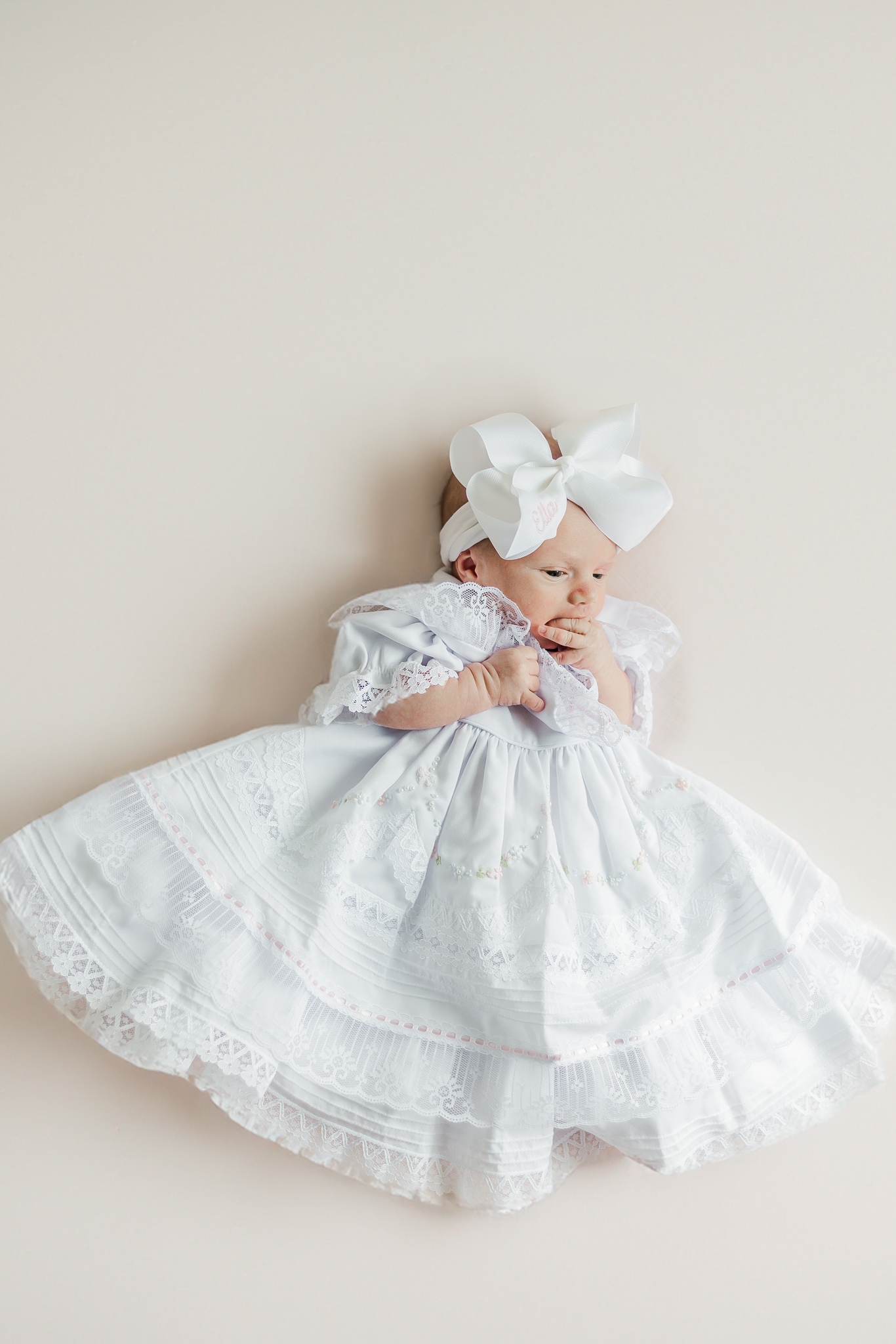 little girl in white ruffle dress taken during session with 5U Photography as part of the family's milestone membership