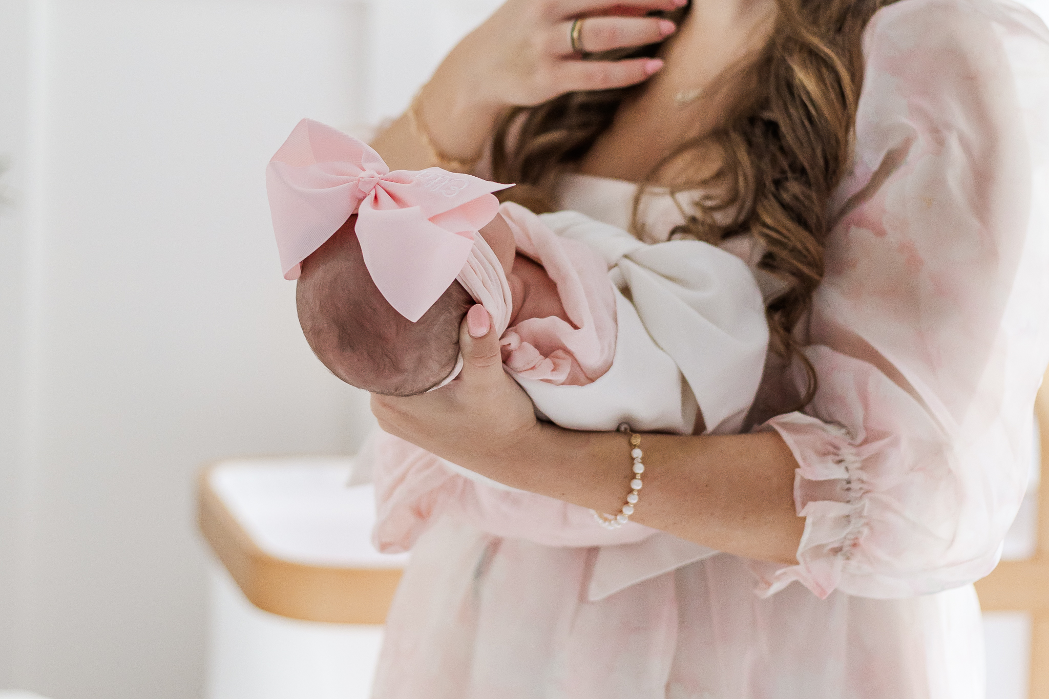 close up of mom holding newborn baby girl during in-home newborn session