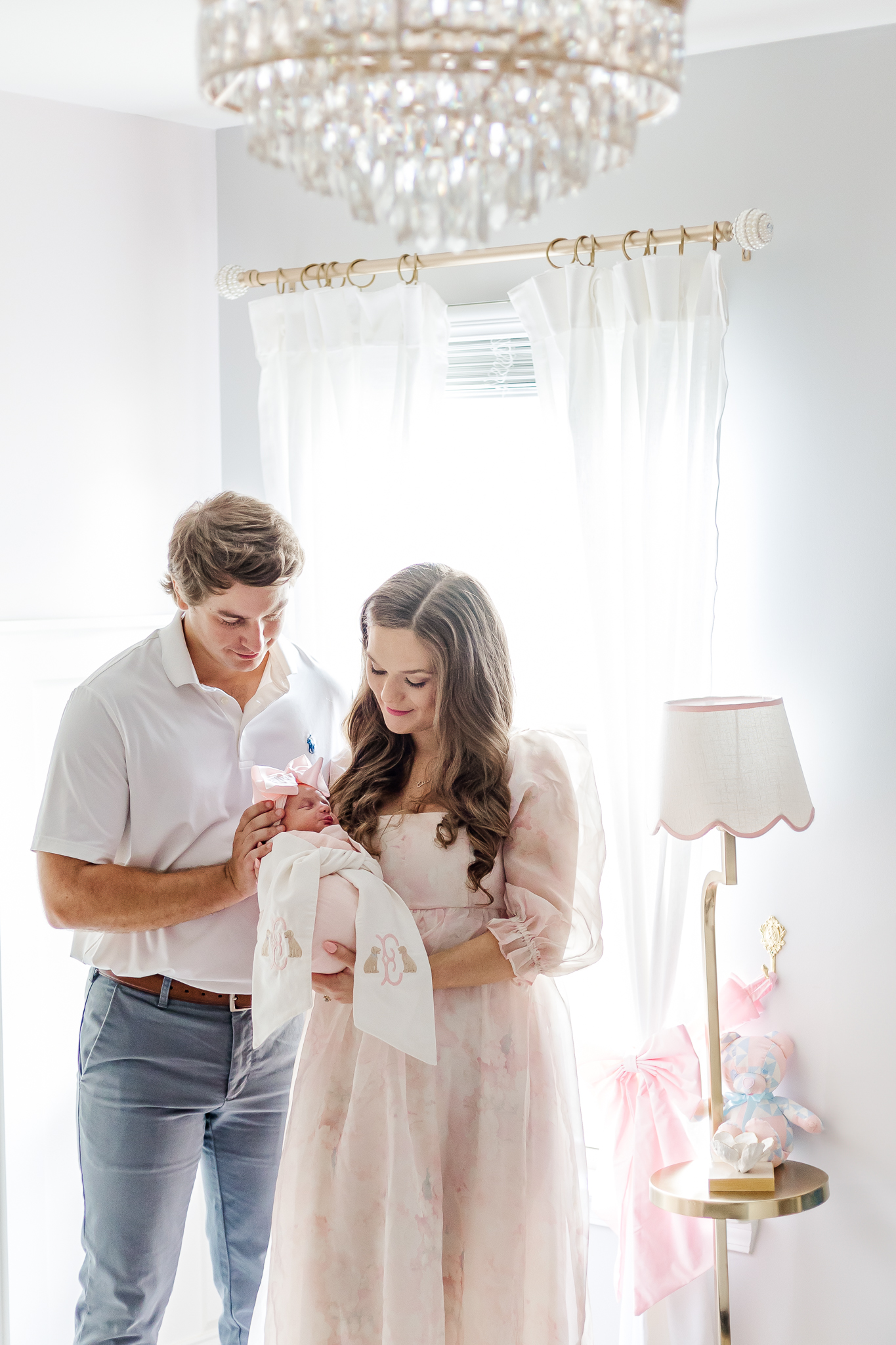 A family portrait featuring a newborn baby girl cradled in her father's arms in birmingham alabama