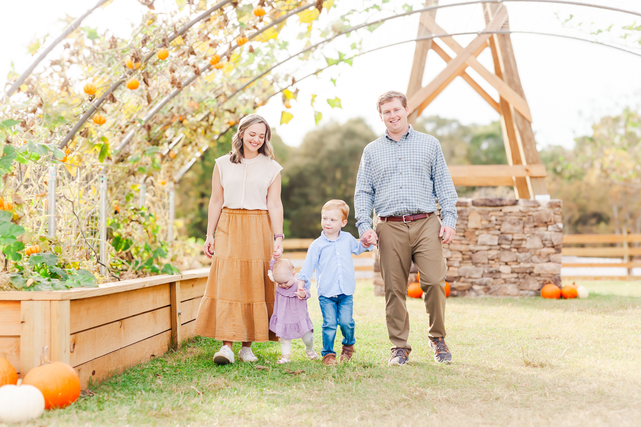 Family holding hands while walking at Old Baker Farm Pumpkin Patch Birmingham AL