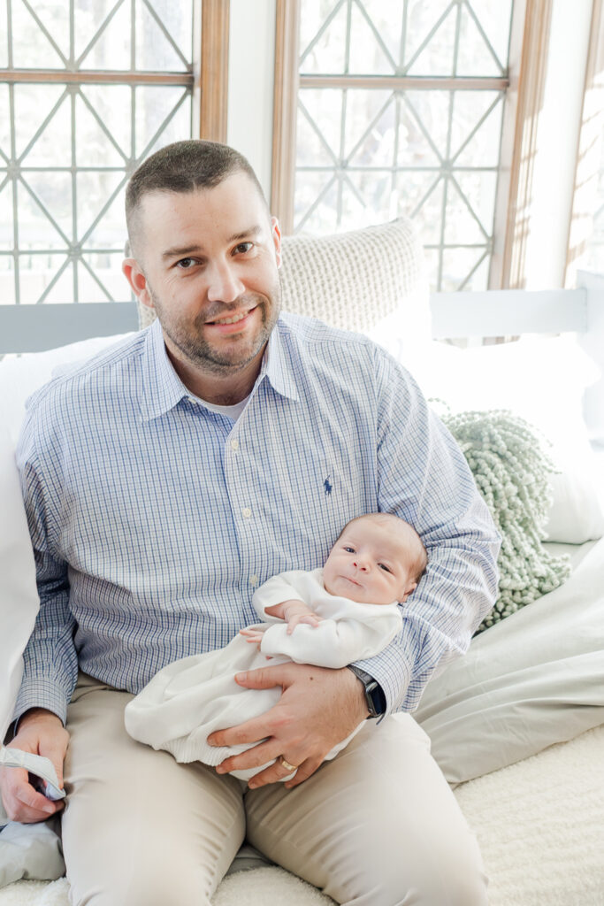 Dad holding newborn baby boy during newborn session with 5U Photography at home in Hoover