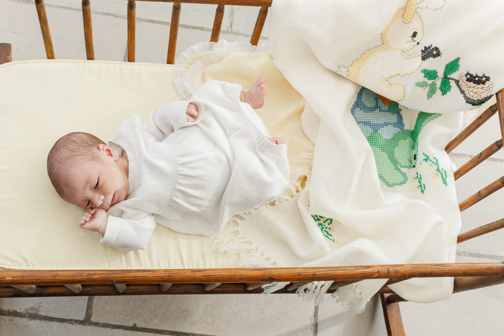 newborn baby boy laying in cradle looking peaceful during in home lifestyle newborn session with 5U Photography in Hoover Alabama