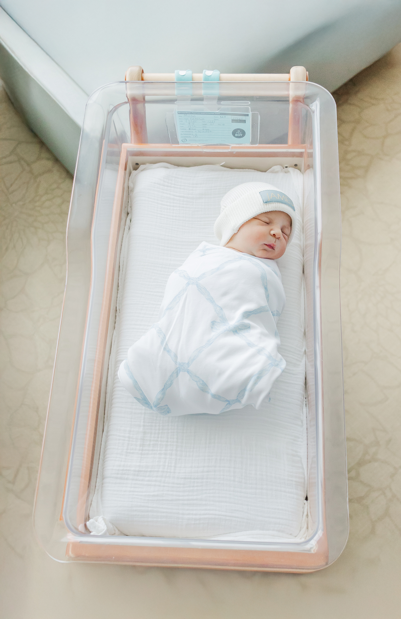 Newborn baby James peacefully resting in his hospital bassinet, showing off his delicate features during a Fresh 48 photo session at Grandview Medical Center.