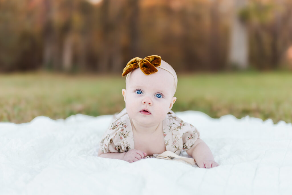 6 month old little girl looking at camera during 6 month milestone session with 5U Photography in Birmingham Alabama