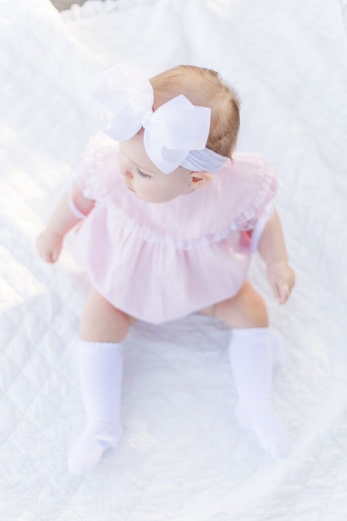 picture of baby girl on her 1st birthday during photo session for 12 month milestone with 5U Photography