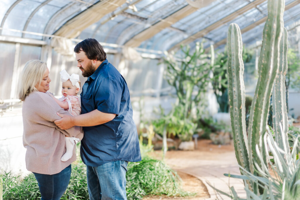 Beautiful family portrait in the vibrant flowers of Birmingham Botanical Gardens, capturing Miss Maggie’s first birthday milestone with 5U Photography.