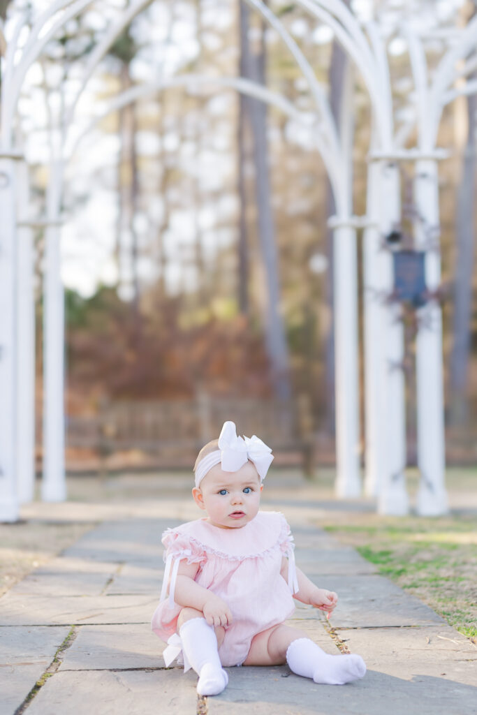 little girl sitting on stone path at Birmingham Botanical Gardens in Birmingham AL 