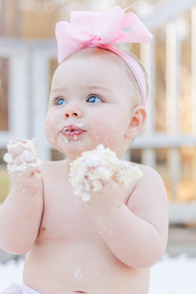 baby girl eating her smash cake during 5U Photography session