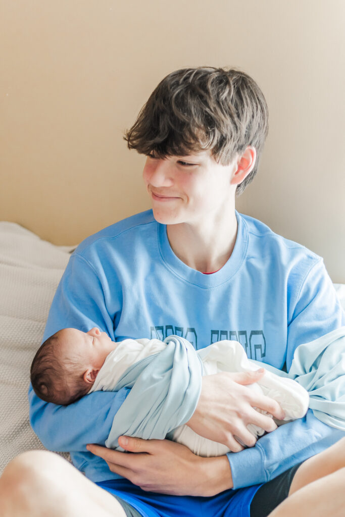 Uncle 'Unc Unc' smiling during newborn session for nephew baby Ezra, in birmingham, alabama