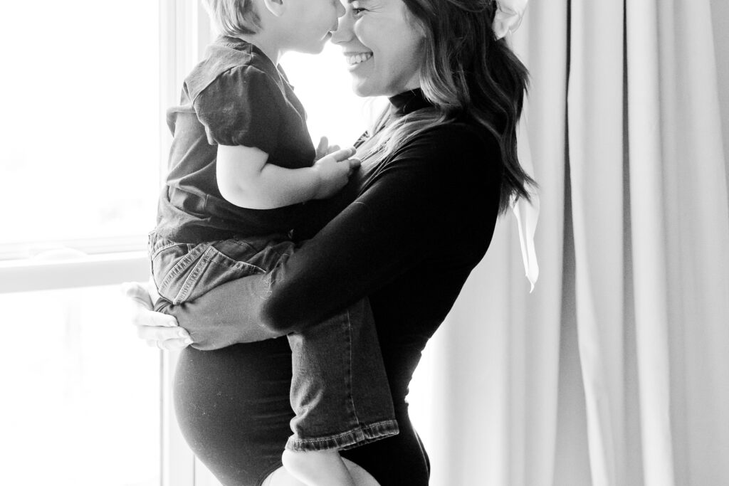 boy kissing mom on the forehead during in-home maternity session with 5U Photography in Birmingham AL