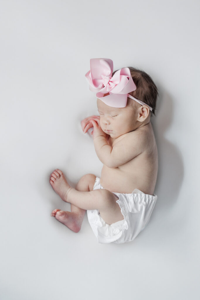 baby girl sleeping on her stomach during photo session with 5U Photography