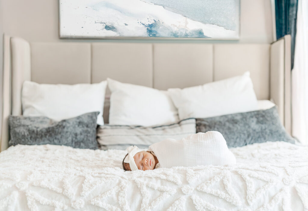 Newborn baby girl Ella Jo peacefully wrapped in a soft blanket during her in-home newborn photo session in Gardendale, Alabama