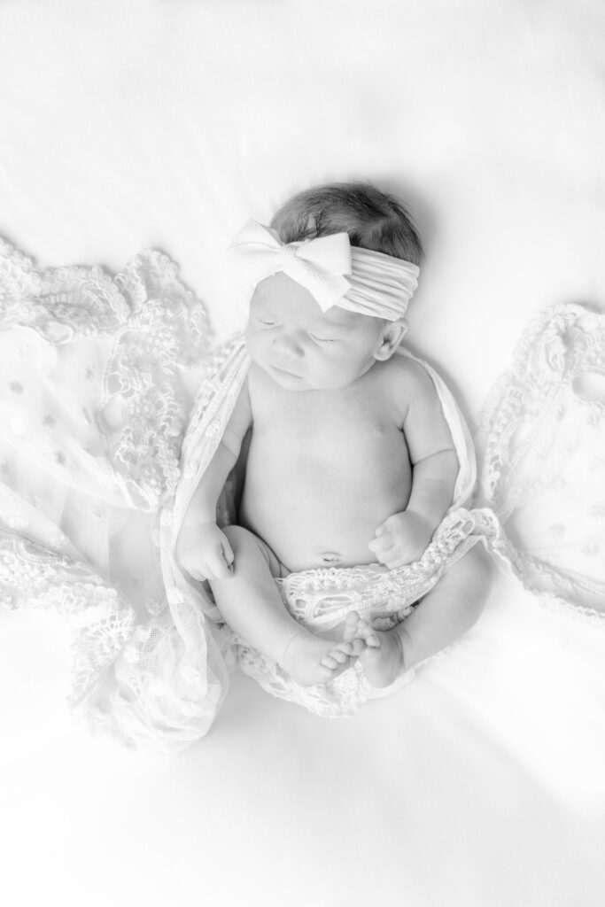 Newborn baby girl Ella Jo dressed in a delicate, soft outfit for her in-home newborn session in Birmingham, Alabama