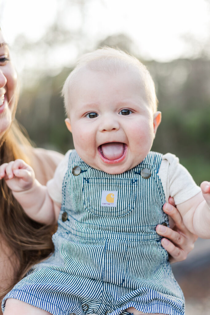 Close-up of baby’s toothless smile, showcasing the joy of their 6-month milestone