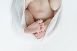 Detail shot of Eleanor’s tiny toes peeking out from her swaddle.
