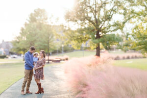 Outdoor autumn family portrait with parents and kids dressed in layered textures—denim jacket, knit sweaters, and corduroy—styled for golden hour light.