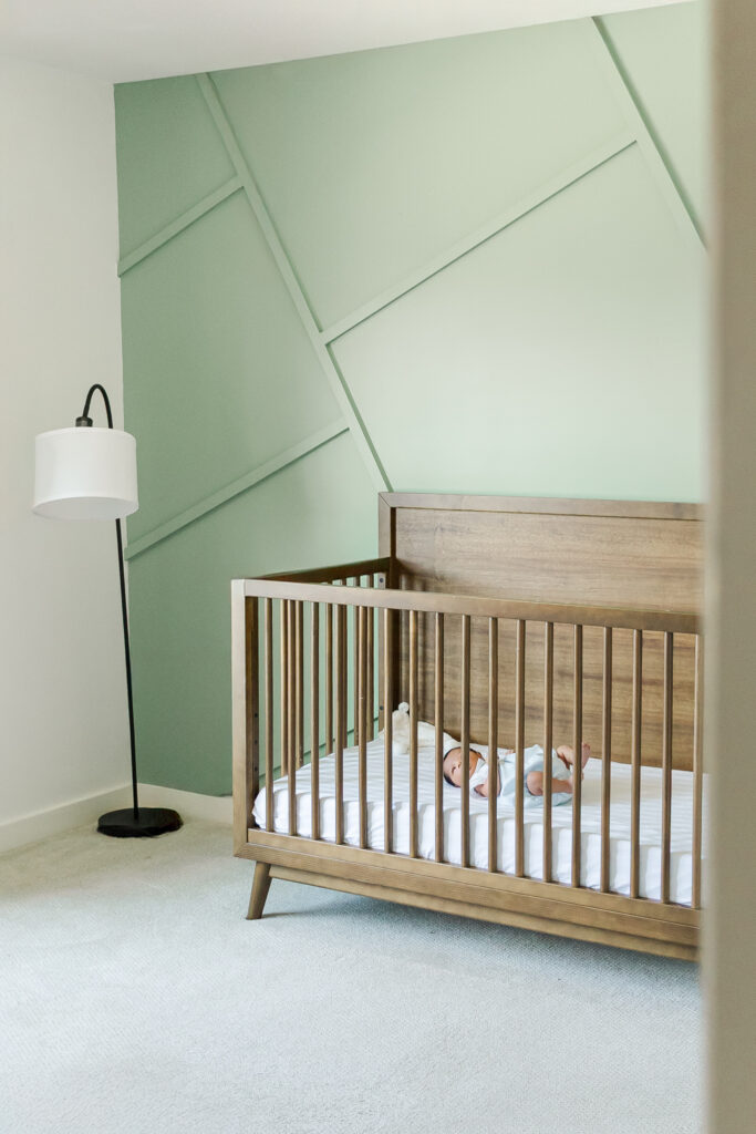 Minimalist nursery design with baby boy in crib during a Trussville, Alabama in-home newborn lifestyle photography session.
